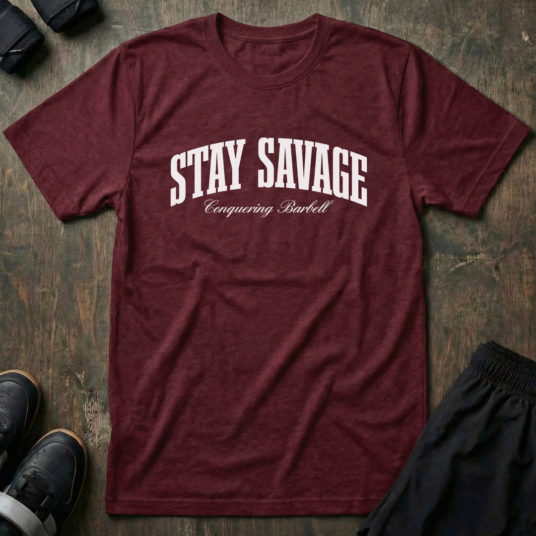 Stay Savage tee in Maroon: STAY SAVAGE in bold arched collegiate letters with Conquering Barbell script below