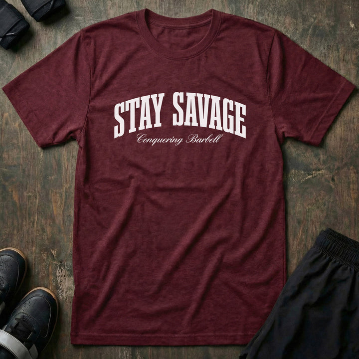 Stay Savage tee in Maroon: STAY SAVAGE in bold arched collegiate letters with Conquering Barbell script below