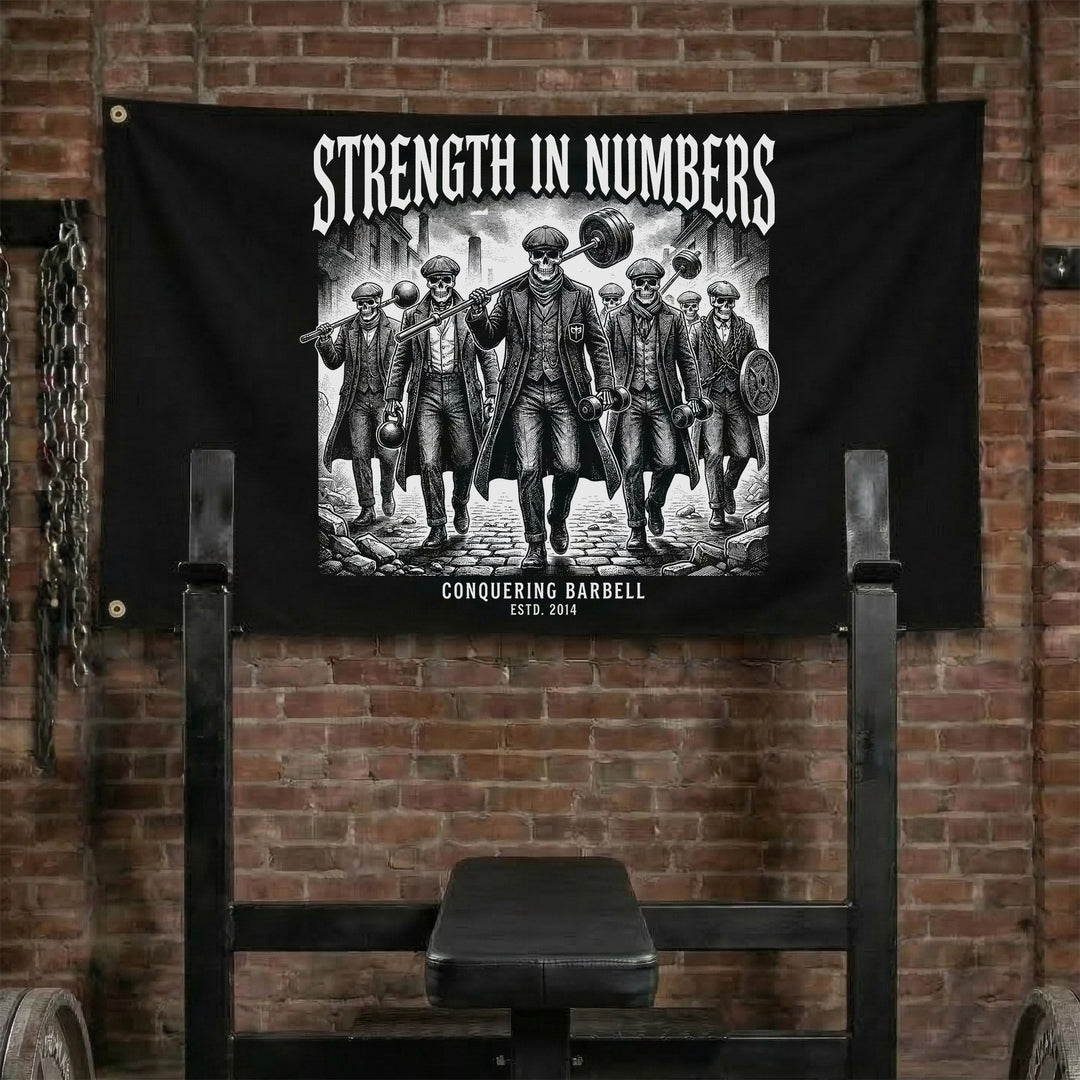 Strength in Numbers - Polyester Flag, horizontal black gym flag with band of warriors standing shoulder to shoulder - Conquering Barbell