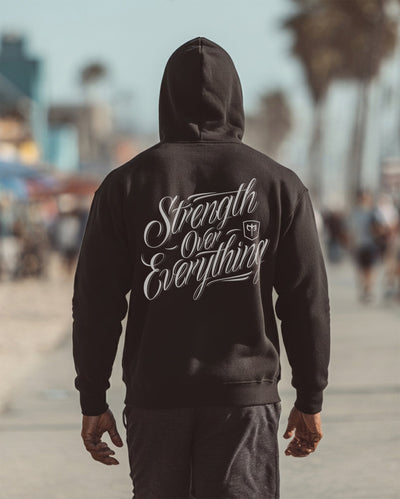Strength Over Everything - on Black Pullover Hoodie - Conquering Barbell