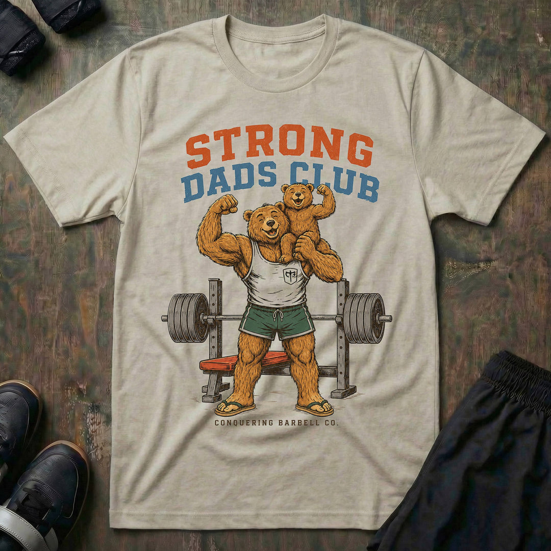 Strong Dads Club tee in Sand: a jacked papa bear in a CB tank top and flip flops grinning