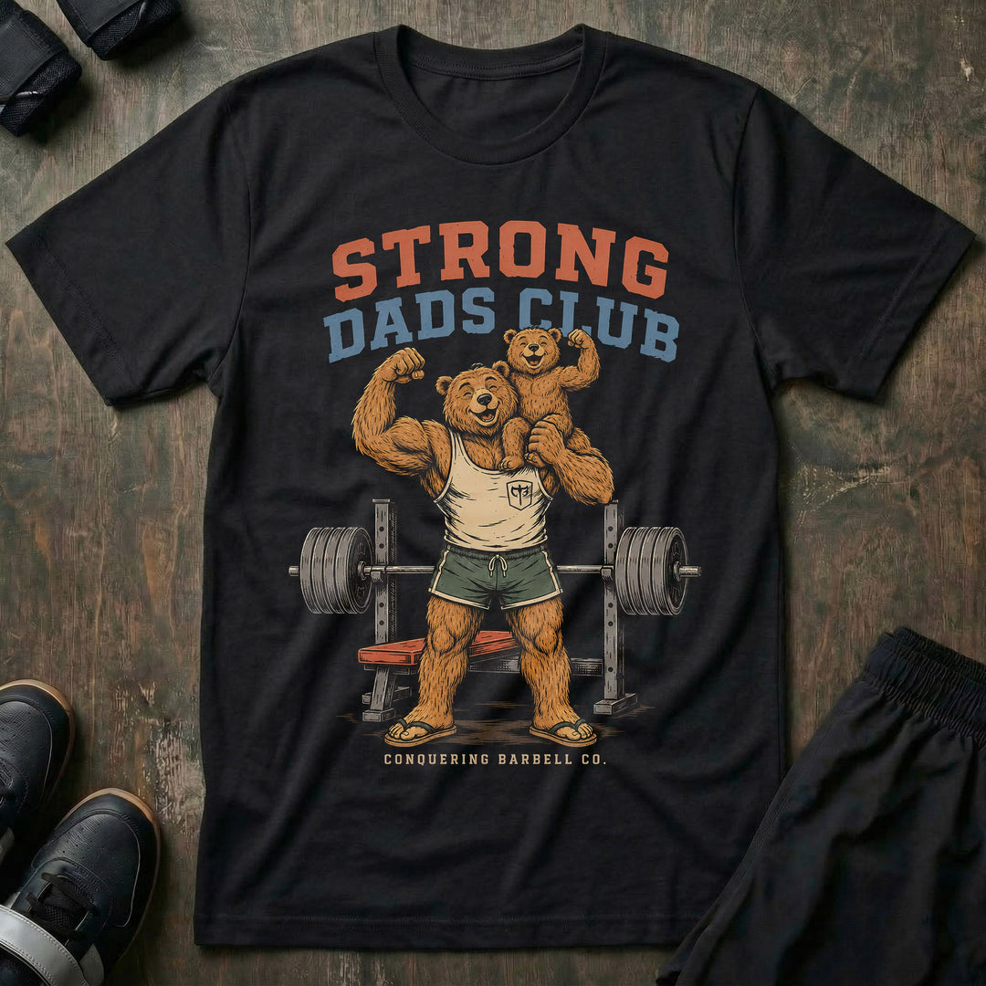 Strong Dads Club tee in Black: a jacked papa bear in a CB tank top and flip flops grinning