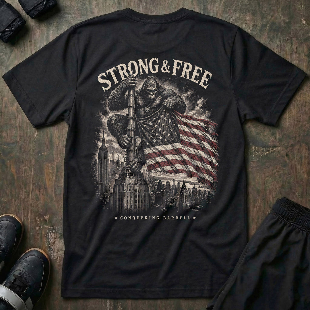 Strong & Free tee in Black: a massive gorilla with the CB shield on his chest standing atop a city skyscraper