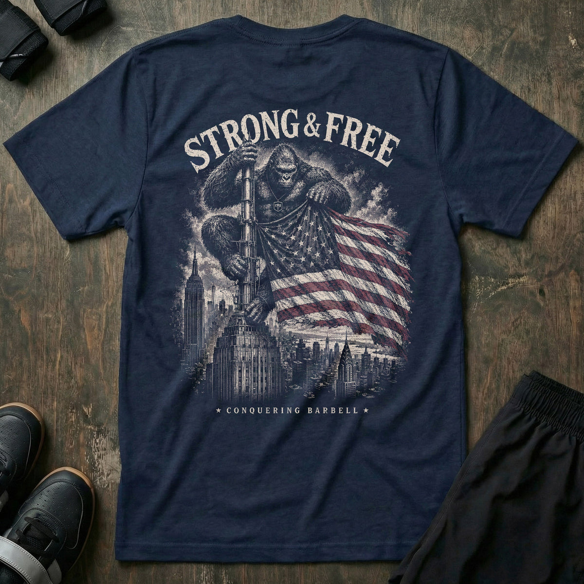 Strong & Free tee in Navy: a massive gorilla with the CB shield on his chest standing atop a city skyscraper