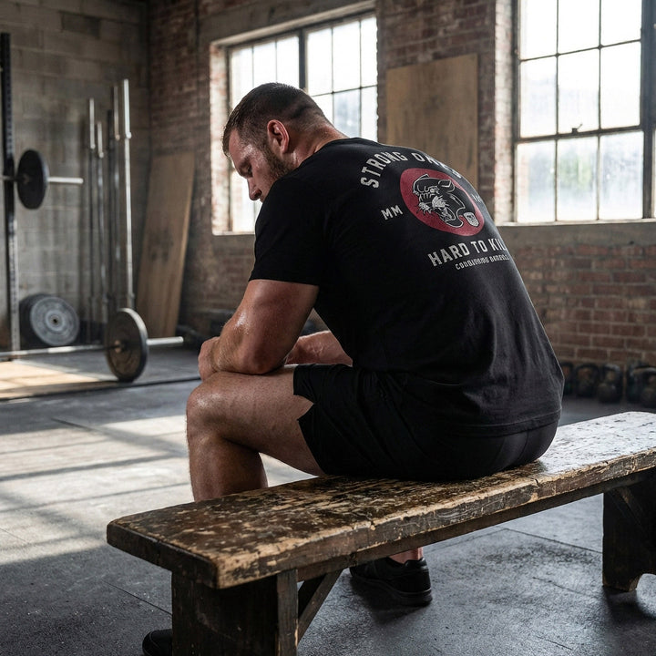Strong Ones Hard to Kill - on Black Tee - Conquering Barbell