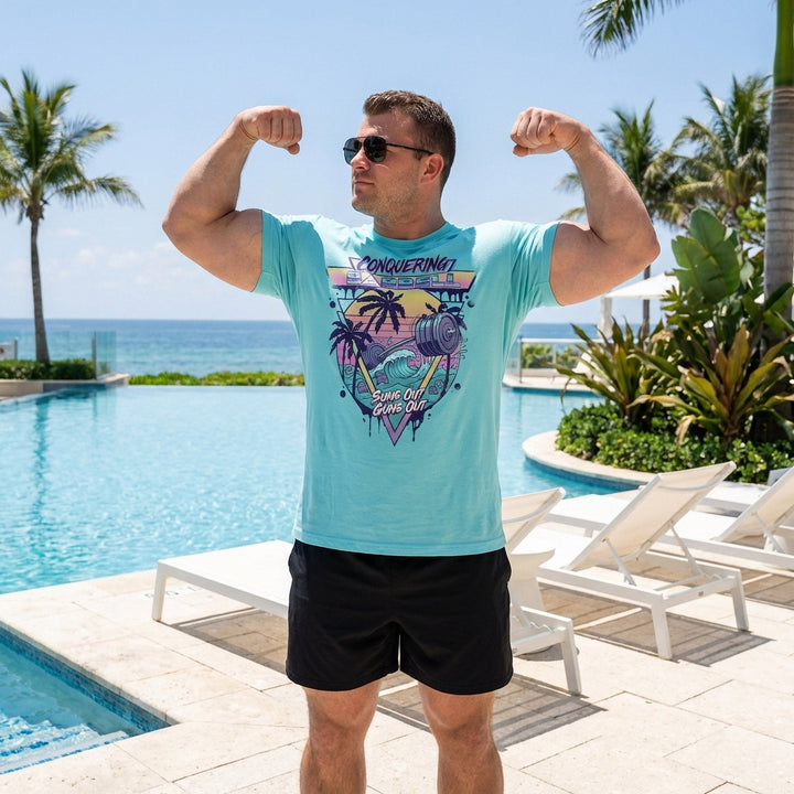 Suns Out Guns Out tee in Tahiti: a barbell rising from ocean waves with palm trees silhouetted against a neon sunset