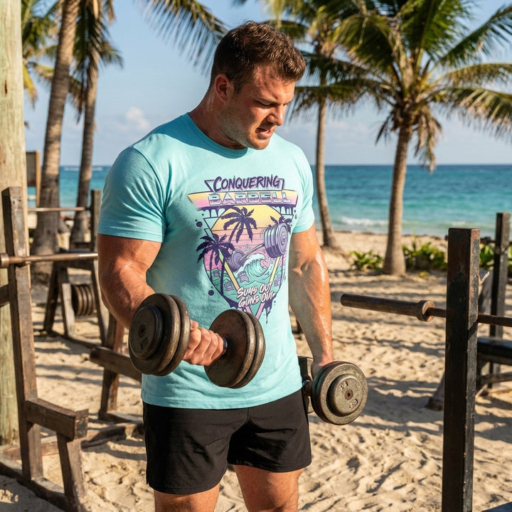 Suns Out Guns Out tee in Tahiti: a barbell rising from ocean waves with palm trees silhouetted against a neon sunset