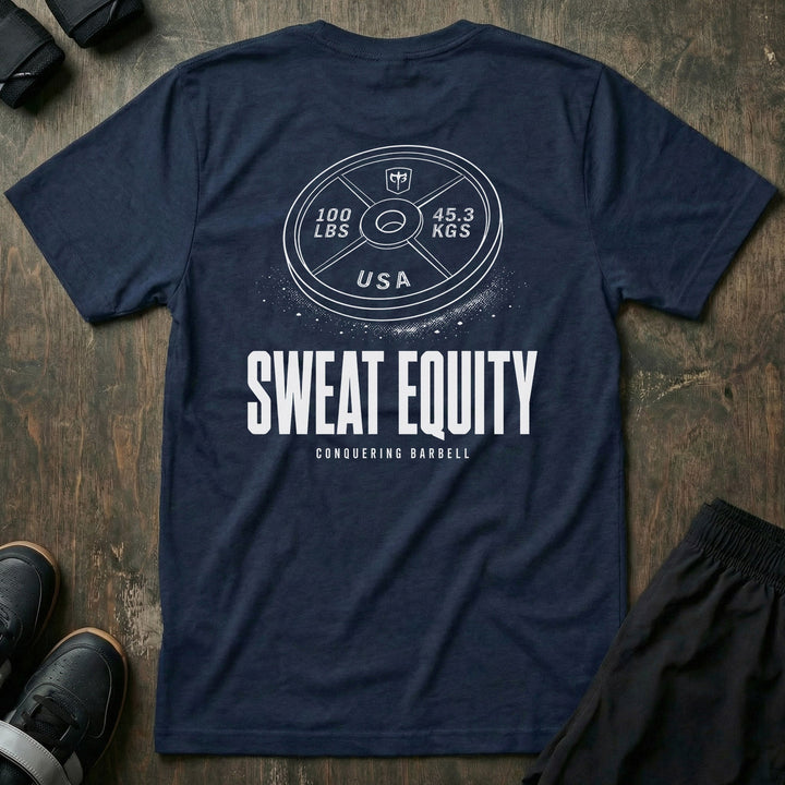 Sweat Equity tee in Navy: a 100 lb USA plate with the CB shield and chalk dust scattered at its base