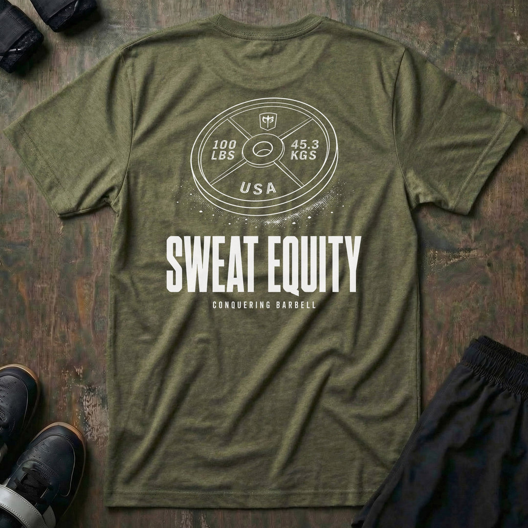 Sweat Equity tee in Military: a 100 lb USA plate with the CB shield and chalk dust scattered at its base