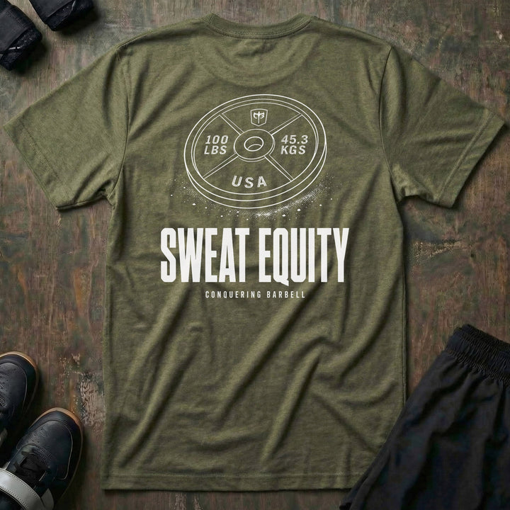 Sweat Equity tee in Military: a 100 lb USA plate with the CB shield and chalk dust scattered at its base