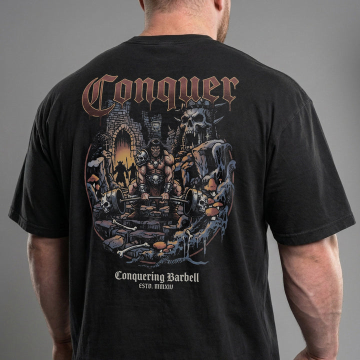 The Barbarian V2 relaxed fit tee in Black: a savage warrior pulling heavy in the ruins of a fallen kingdom
