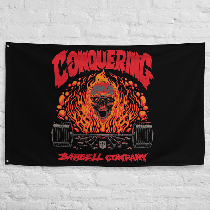 The Flaming Skull - Polyester Flag, horizontal gym flag hanging in a home gym - Conquering Barbell