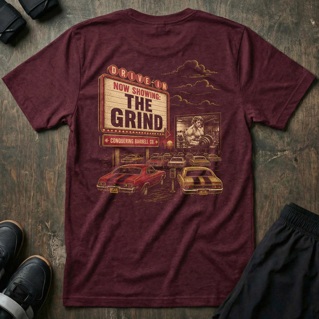 The Grind tee: a retro drive-in marquee reading NOW SHOWING