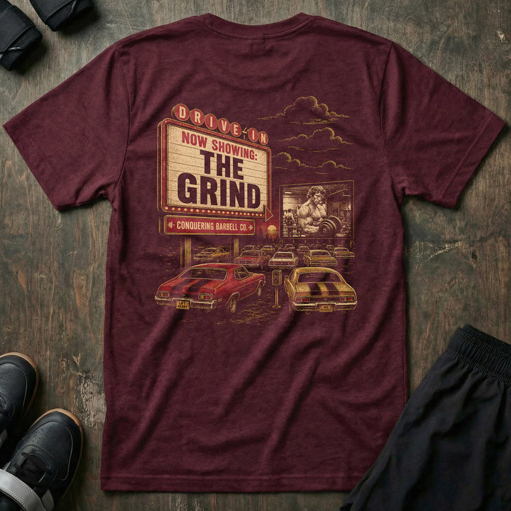 The Grind tee: a retro drive-in marquee reading NOW SHOWING