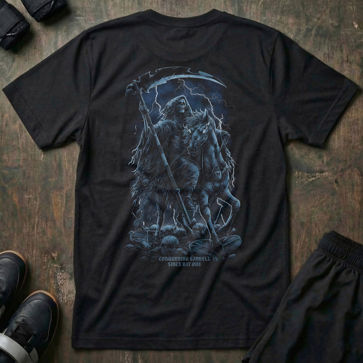 The Reaper tee in Black: a hooded reaper with his scythe riding out of the shadows in cold grey and steel blue