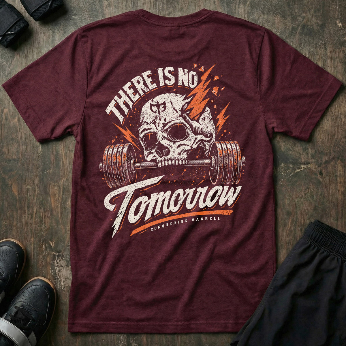 There is No Tomorrow tee in Maroon: a cracked skull biting down on a loaded barbell between orange lightning bolts