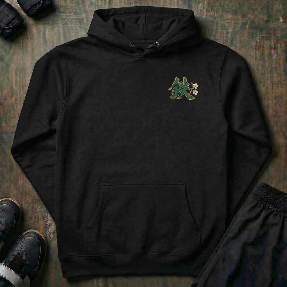 Three Powers pullover hoodie in Black, left chest: green brush kanji for iron with cherry blossoms