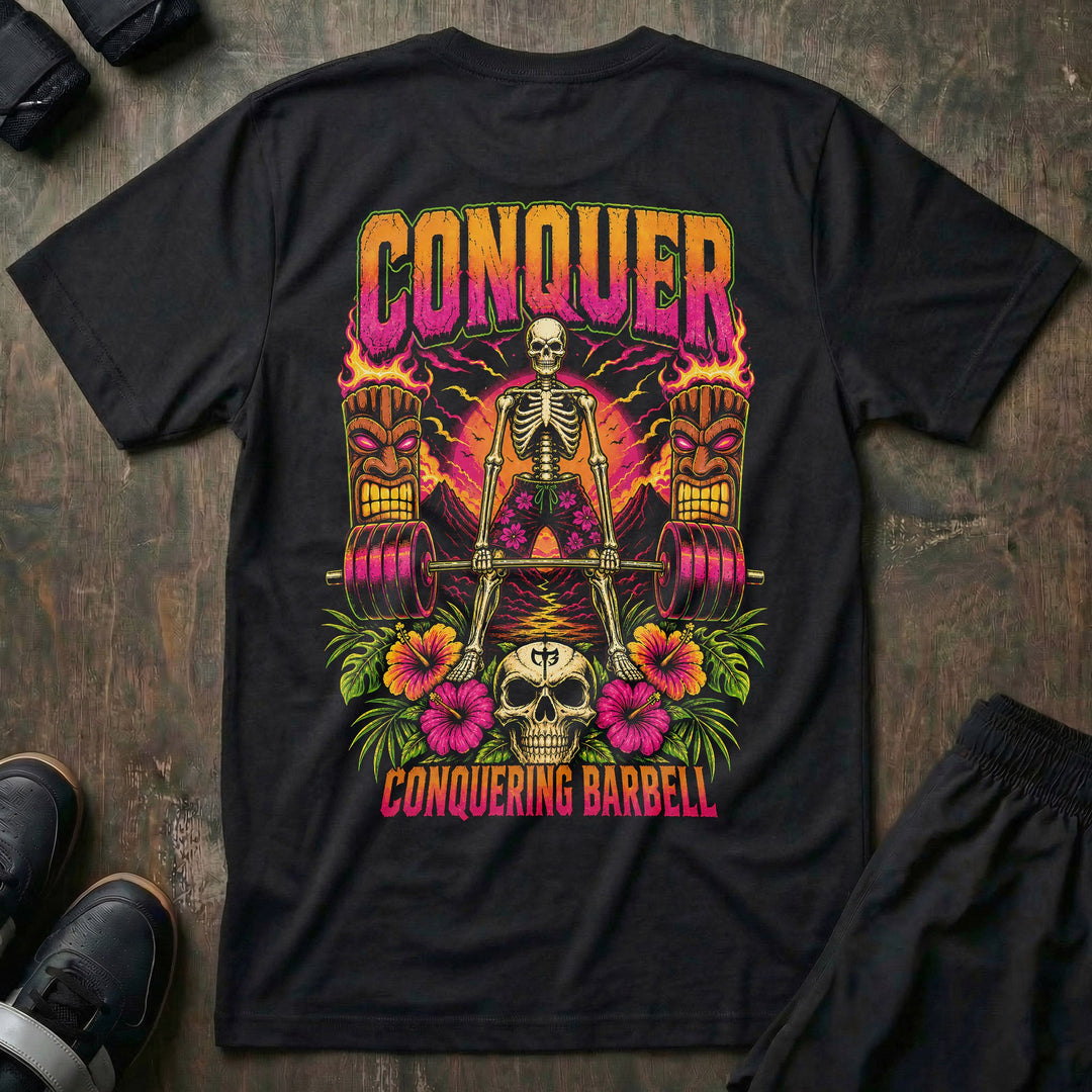 Tiki Power tee in Black: a skeleton deadlifting a loaded barbell between two flaming tiki torches against a tropical sunset