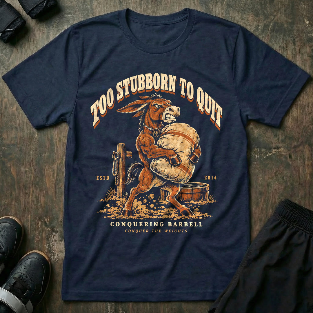 Too Stubborn to Quit - Tee front graphic in Navy with a mule with teeth bared carrying a heavy sandbag - Conquering Barbell
