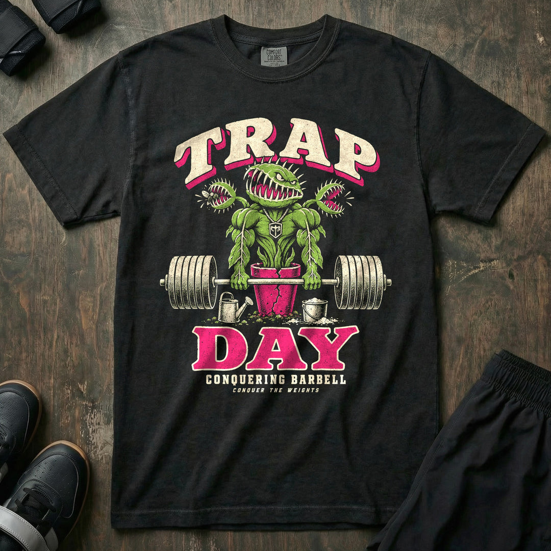 Trap Day - Relaxed Fit Tee front graphic in Black with a muscular Venus flytrap in a pot shrugging a loaded barbell - Conquering Barbell