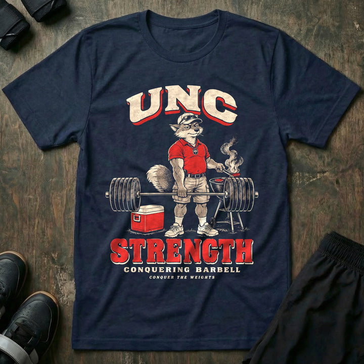 Unc Strength - Tee front graphic in Navy with a silver fox in a polo holding a loaded barbell one-handed while flipping burgers on a grill - Conquering Barbell