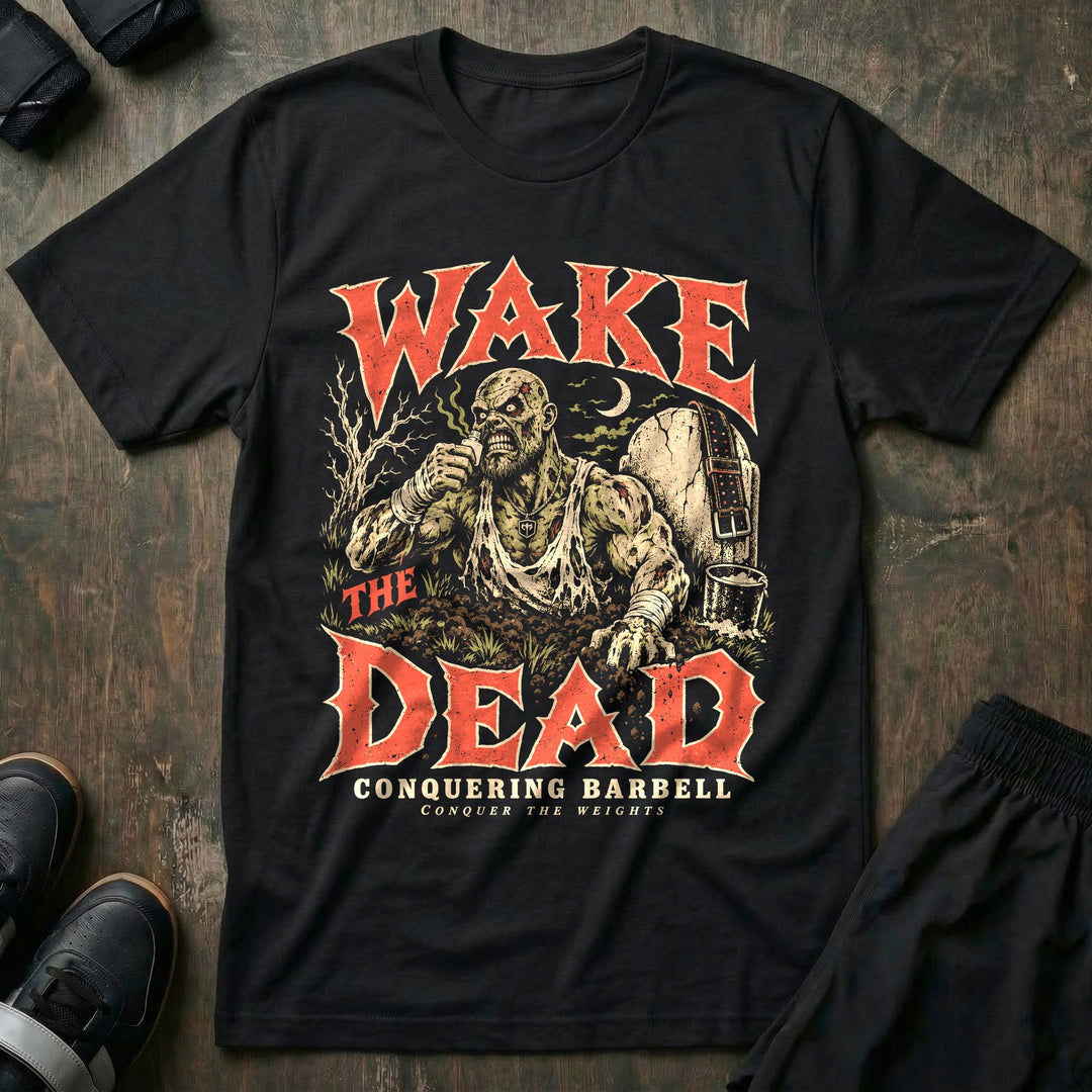 Wake the Dead - Tee front graphic in Black with a zombie lifter rising from the grave on smelling salts - Conquering Barbell