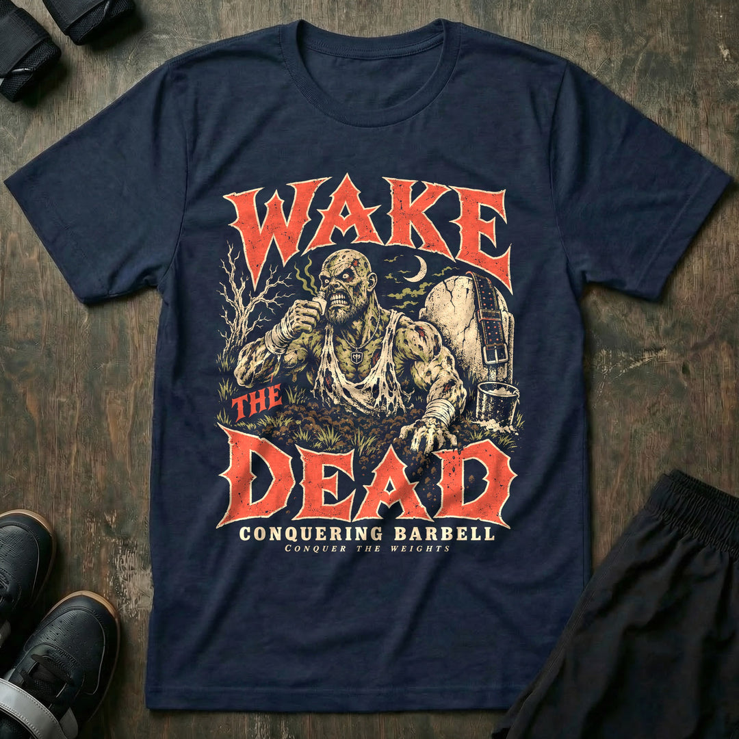 Wake the Dead - Tee front graphic in Navy with a zombie lifter rising from the grave on smelling salts - Conquering Barbell