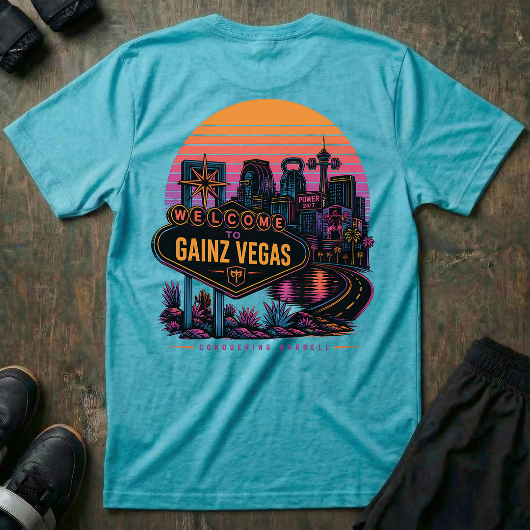 Welcome to Gainz Vegas tee in Tahiti: a neon-soaked city skyline at sunset with a WELCOME TO GAINZ VEGAS marquee sign