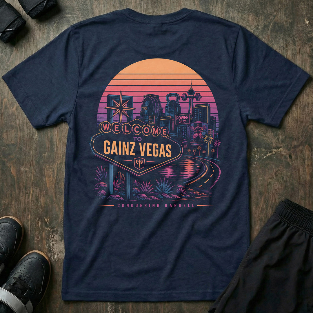 Welcome to Gainz Vegas tee in Navy: a neon-soaked city skyline at sunset with a WELCOME TO GAINZ VEGAS marquee sign