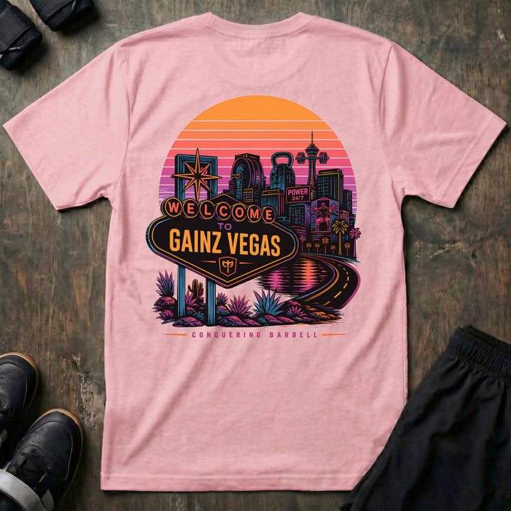 Welcome to Gainz Vegas tee in Pink: a neon-soaked city skyline at sunset with a WELCOME TO GAINZ VEGAS marquee sign