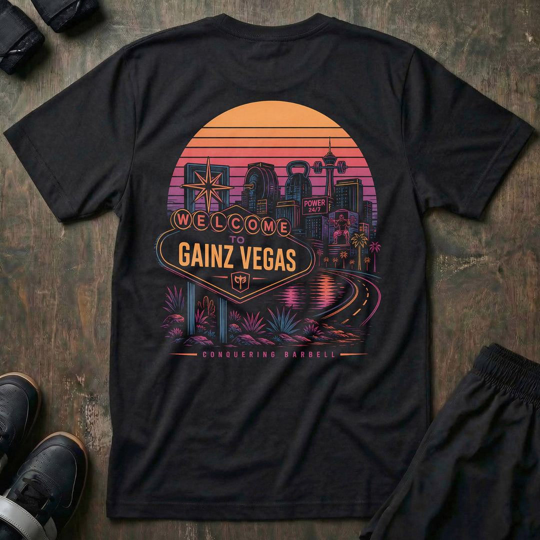Welcome to Gainz Vegas tee in Black: a neon-soaked city skyline at sunset with a WELCOME TO GAINZ VEGAS marquee sign