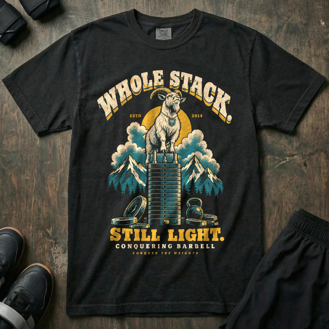 Whole Stack Still Light - Relaxed Fit Tee front graphic in Black with a mountain goat standing on top of a machine weight stack above the clouds - Conquering Barbell