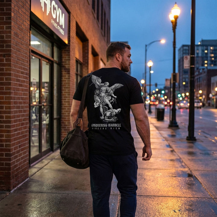 Win the Day Angel vs Dem tee in Black: a winged guardian driving his weapon down on a demon in a classic engraving style
