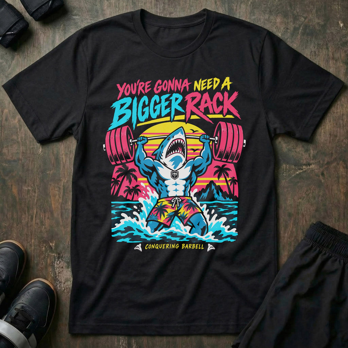 You're Gonna Need A Bigger Rack tee in Black: a jacked great white shark bursting out of the ocean in board shorts