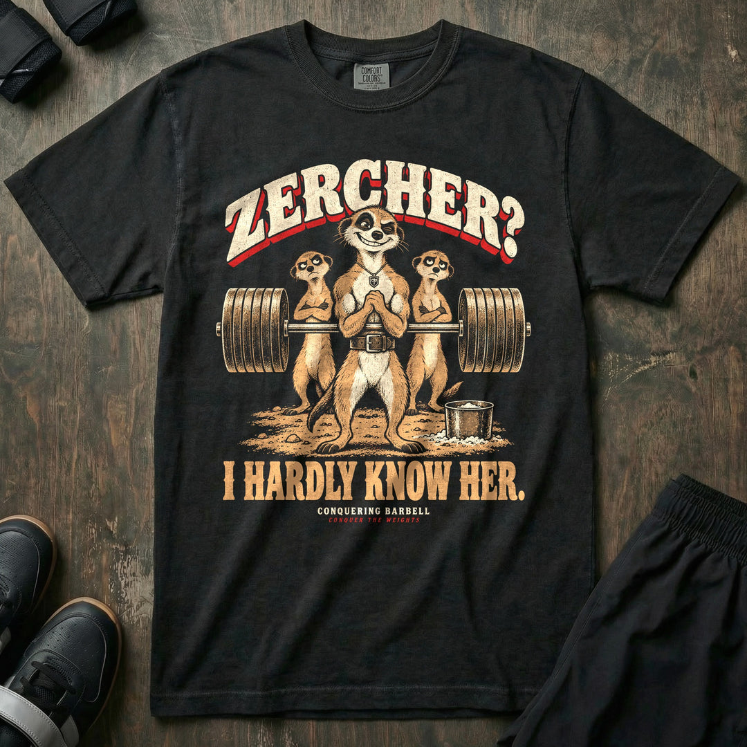 Zercher I Hardly Know Her - Relaxed Fit Tee front graphic in Black with a winking meerkat holding a loaded barbell in a Zercher carry while two meerkats look unimpressed - Conquering Barbell