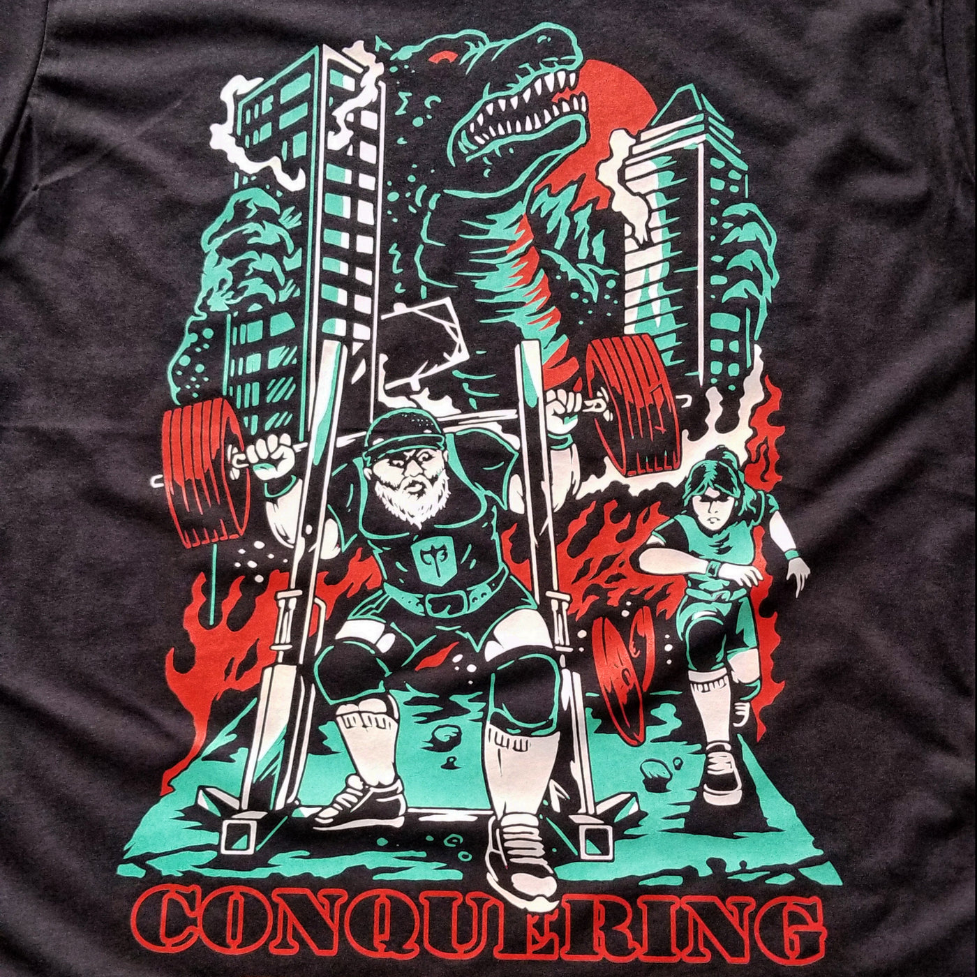 Attack of The Gainzilla - on Black Tee - Conquering Barbell